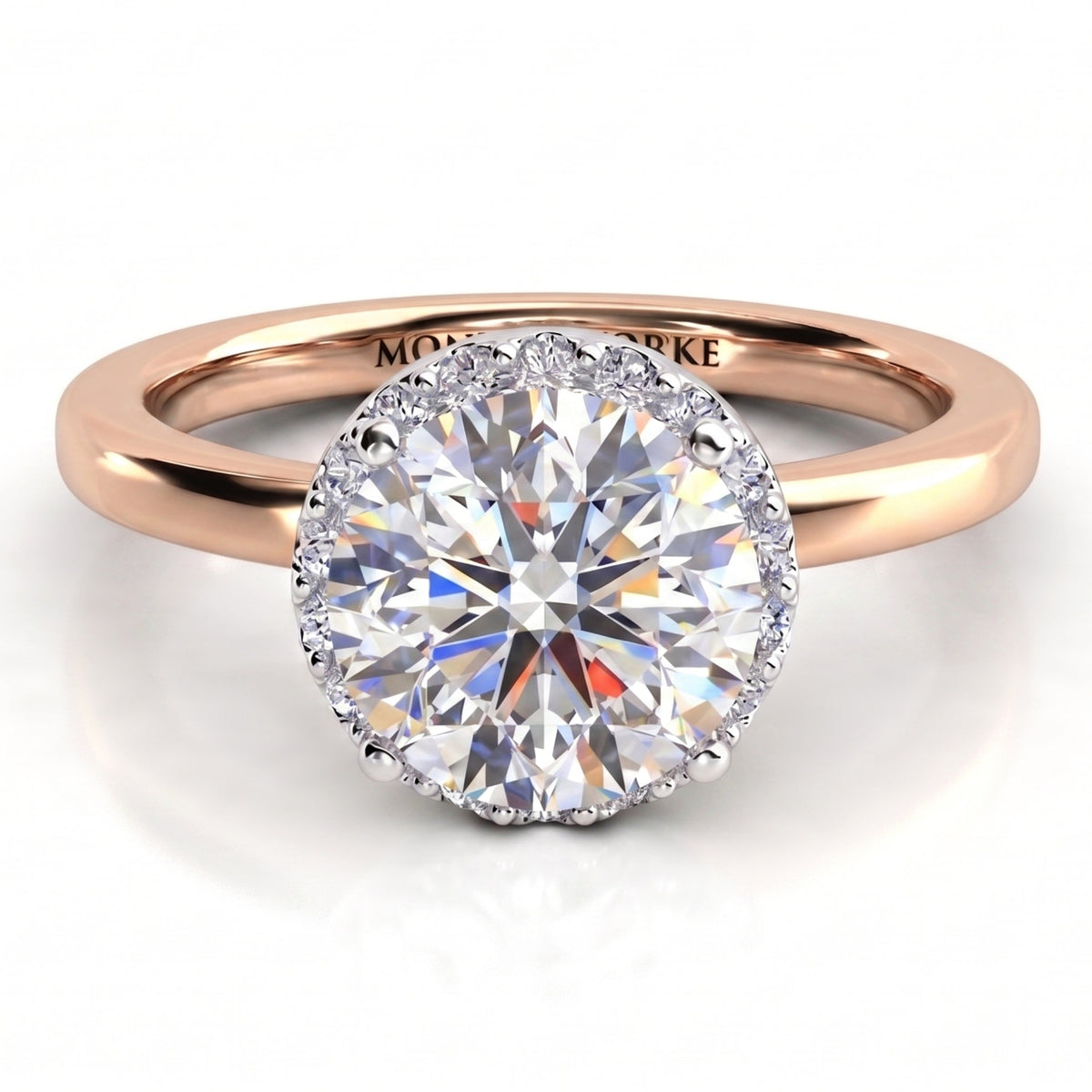 Alexa unique diamond engagement ring in rose gold, top view showing the halo edge following the outline of the round centre diamond.