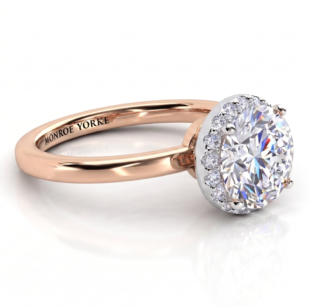 Alexa unique halo engagement ring in rose gold, low front view of the round centre diamond above a plain polished band.