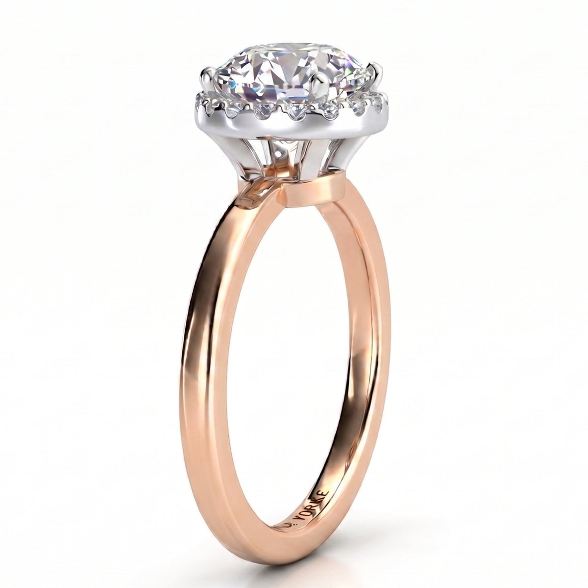 Alexa unique diamond ring in rose gold, side profile showing half the halo tucked under the centre diamond and the white metal setting head.