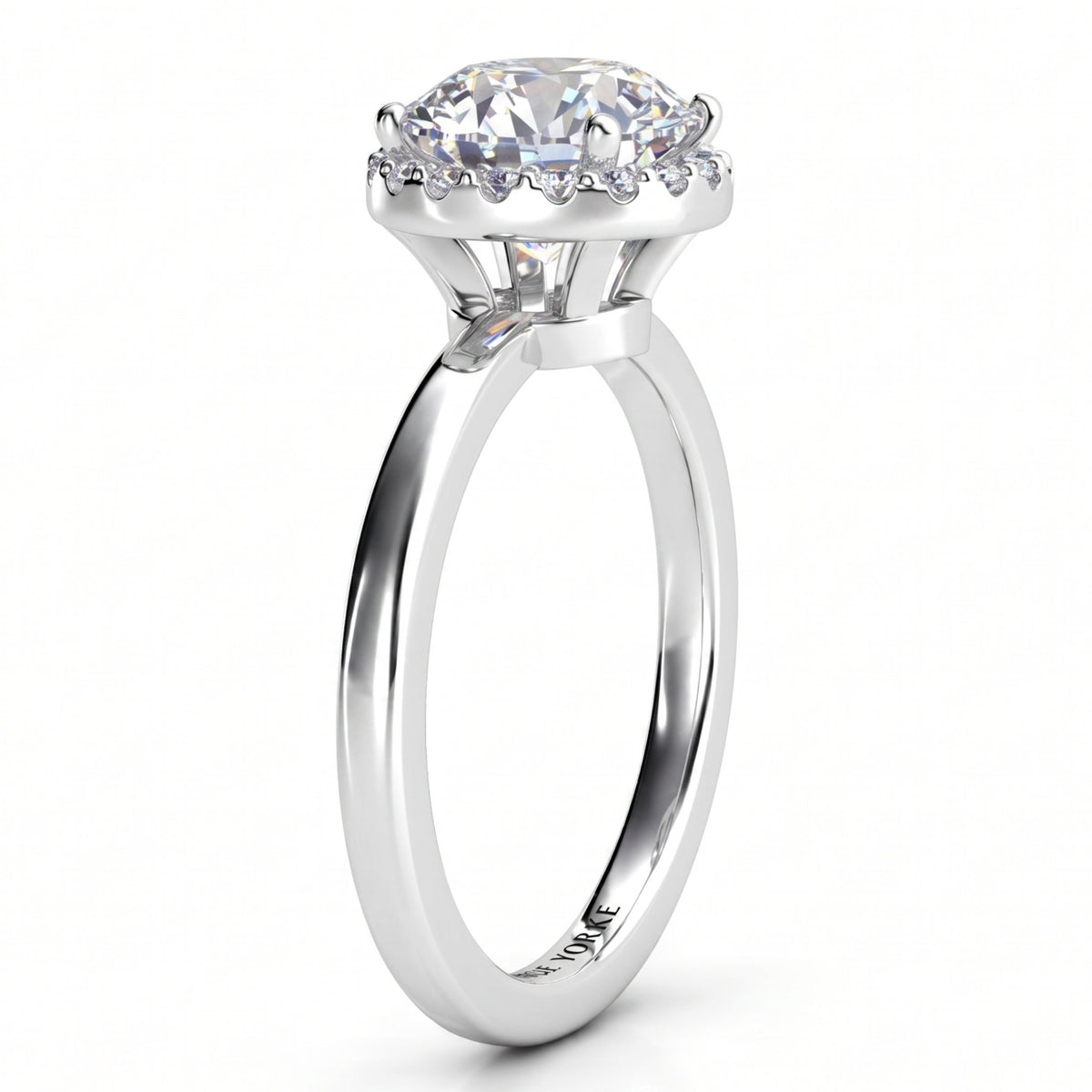 Alexa unique diamond ring in white gold or platinum, side profile showing half the halo tucked under the centre diamond.