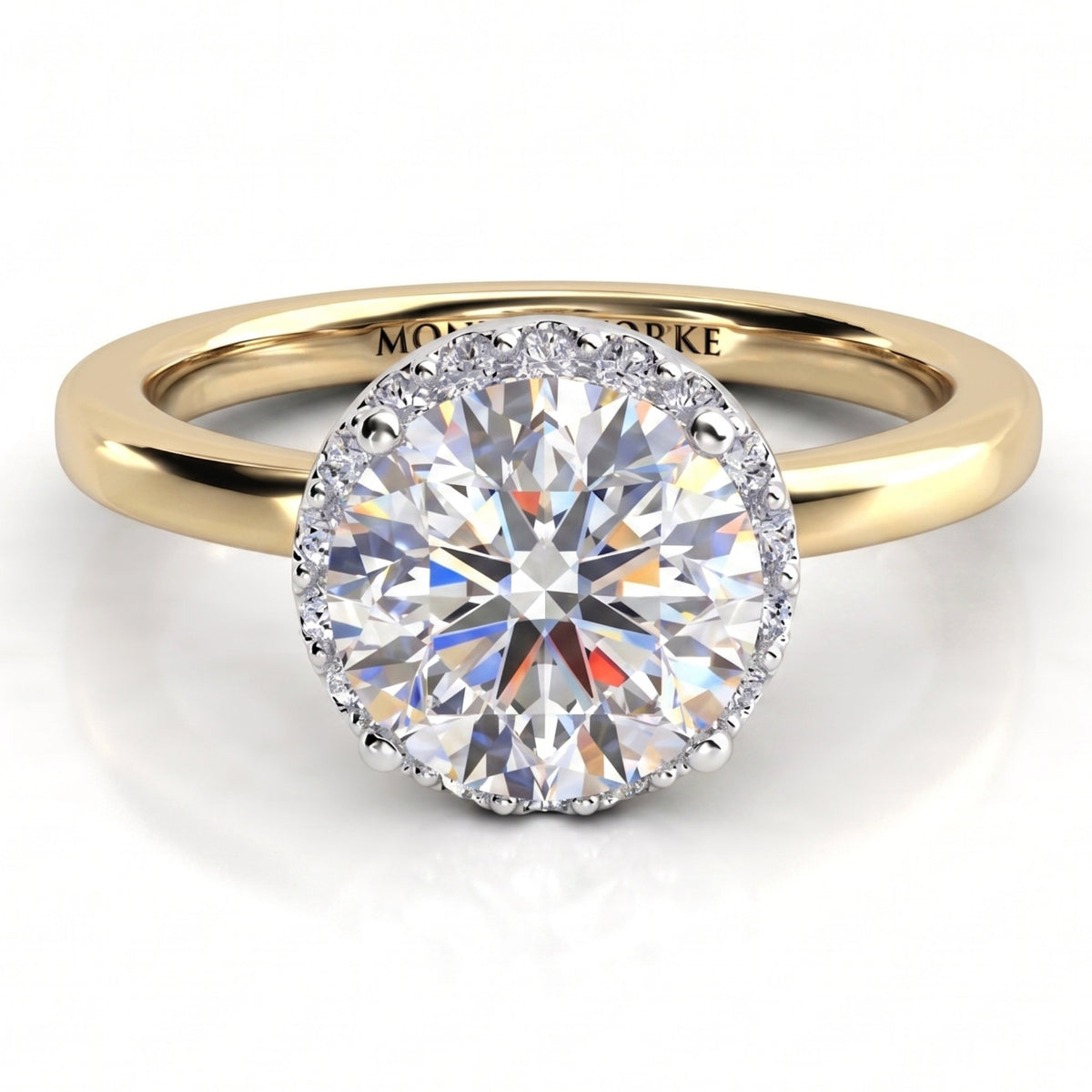 Alexa unique diamond engagement ring in yellow gold, top view showing the halo edge following the outline of the round centre diamond.