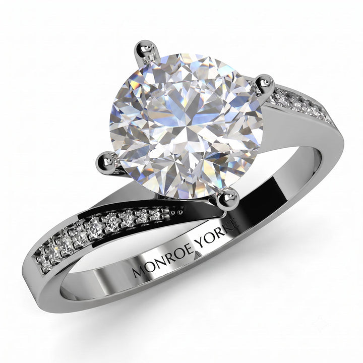 Arbella round brilliant diamond engagement ring in white gold, top view of the swinging pave band