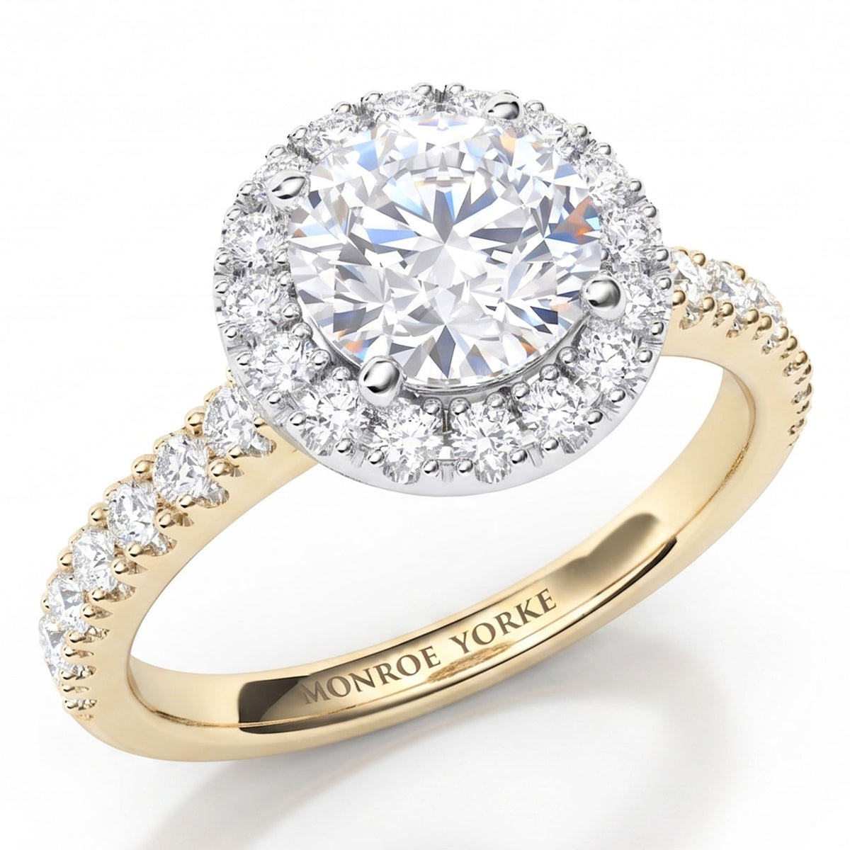 Ariana - a yellow gold halo engagement ring featuring a round brilliant-cut centre stone surrounded by a halo of smaller diamonds, with a shank paved with small round diamonds.
