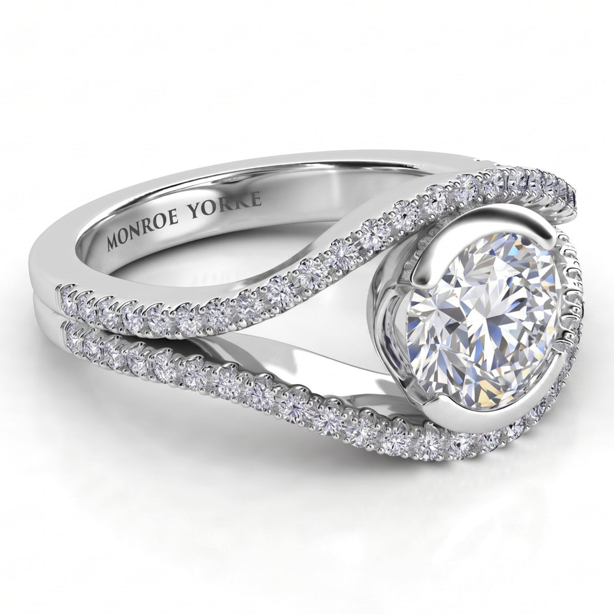 Capri engagement ring in white gold or platinum, the two bands crossing past each other to cradle the round brilliant centre diamond.
