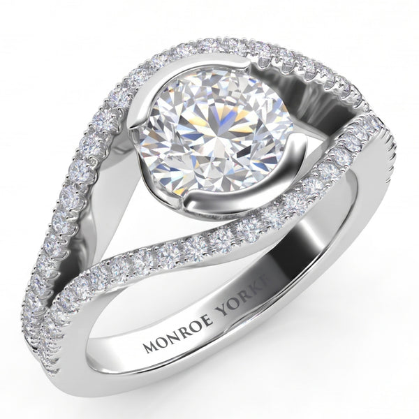 Capri halo engagement ring in white gold or platinum, angled view of the round brilliant centre diamond cradled between two diamond set bands that curve around it.