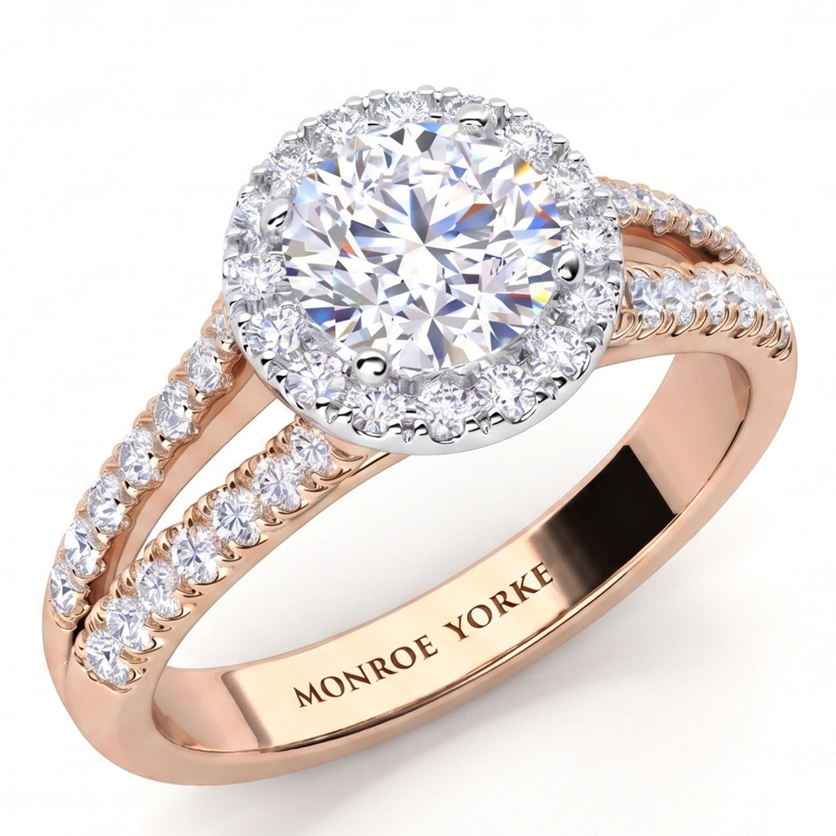 Ceduna - Rose gold halo engagement ring with a round-cut centre stone and small pavé-set accent stones along the split shank, shown on a white background. The inside of the band is engraved with the brand name 'MONROE YORKE'.