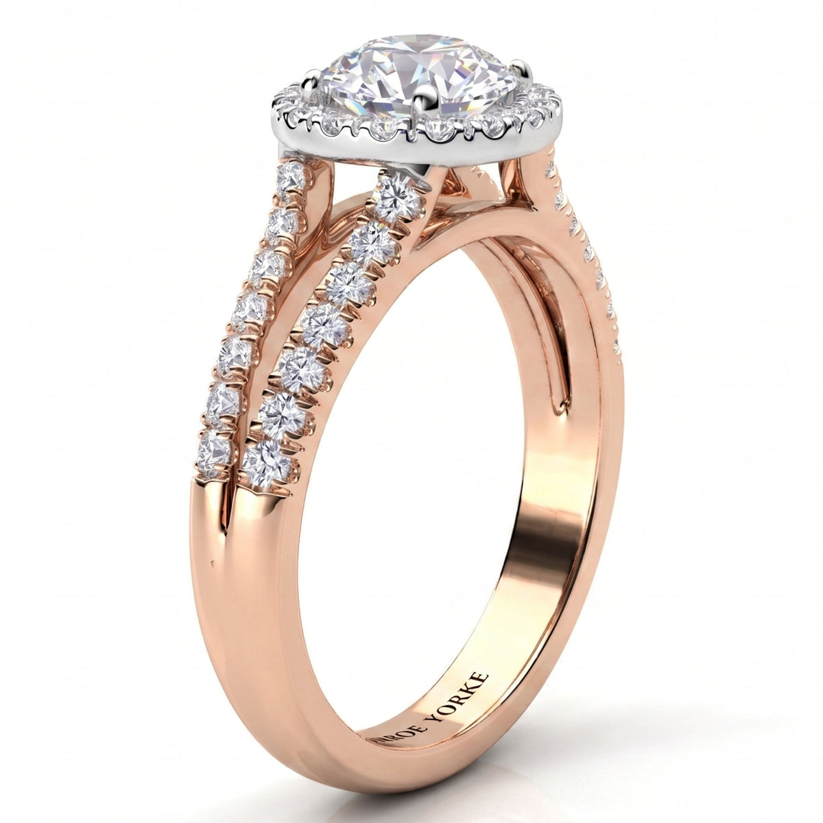 A rose gold halo ring with a round-cut diamond centre stone and pavé-set diamonds along the split shank, shown on a clean white background.