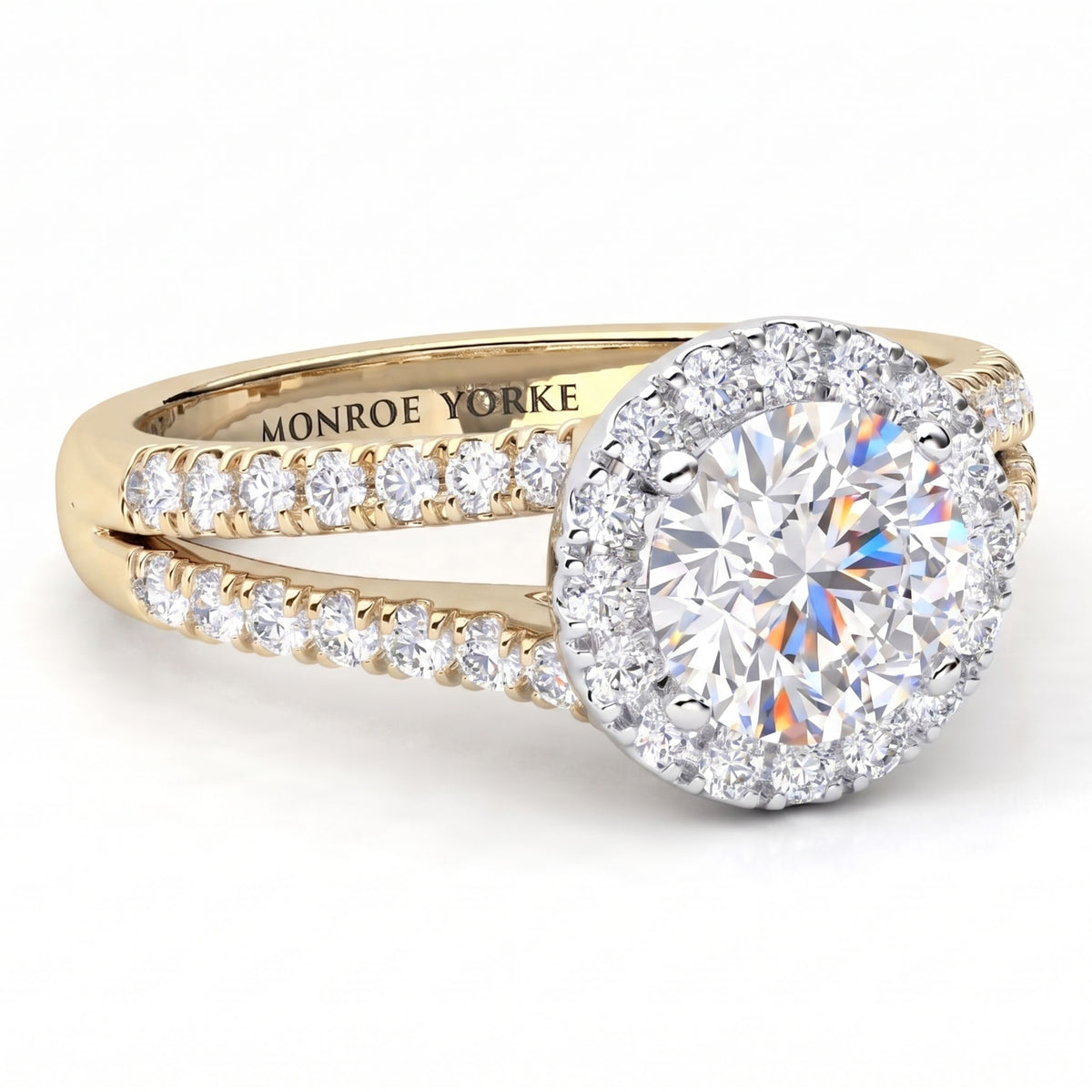 Ceduna - A yellow gold halo ring with a round brilliant-cut centre stone and pavé-set diamonds along the split shank. The inside of the band is engraved with 'MONROE YORKE'.