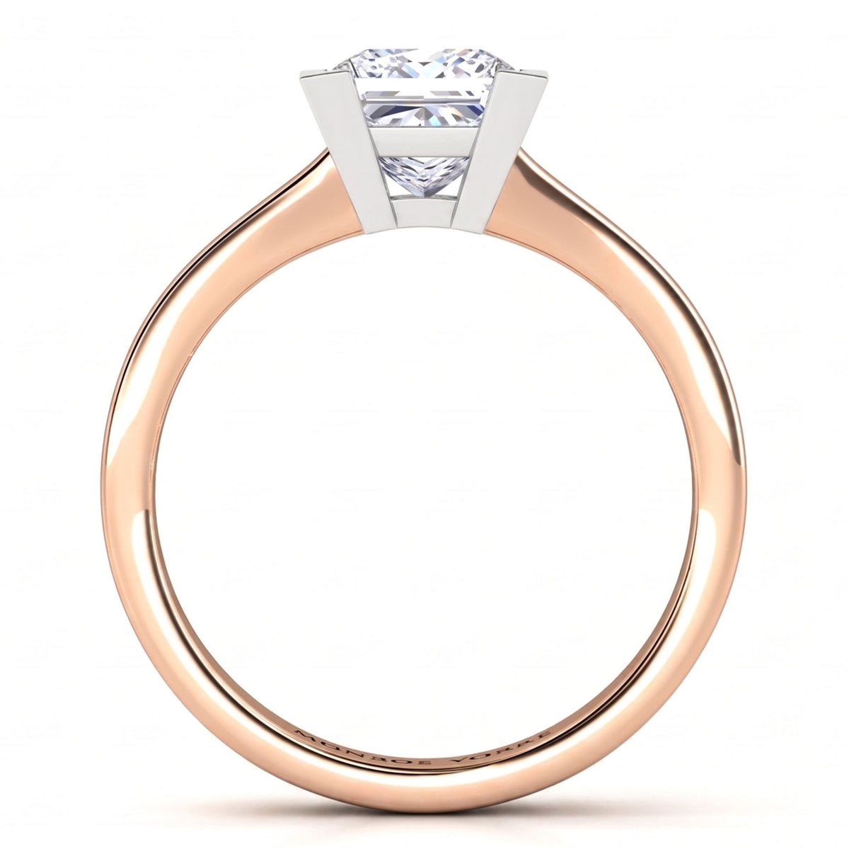 Chester rose gold solitaire engagement ring, side view of the princess cut centre diamond in a V claw setting above a plain tapered band.