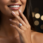 Dune pear shape diamond ring with a halo and diamonds on the band on a girls hand