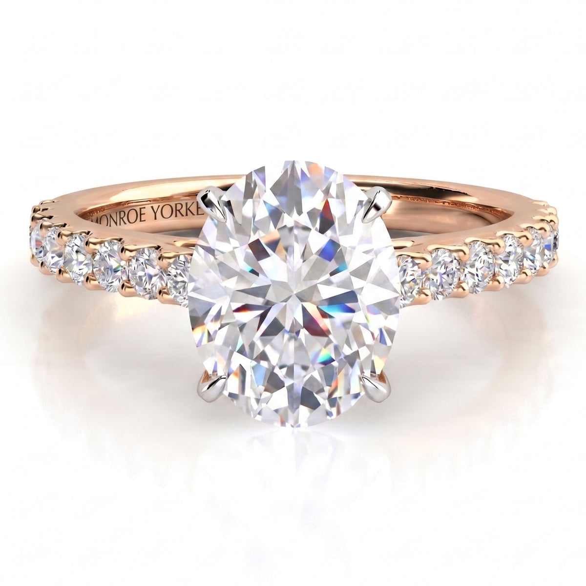 Rose gold diamond engagement ring with a large oval centre stone and small diamonds along the shoulders, shown on a clean white background.