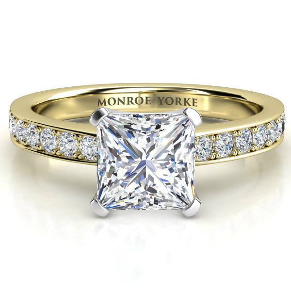 Fifth Avenue Princess cut diamond ring in gold. Centre square princess cut diamond with pave set diamonds on the band.