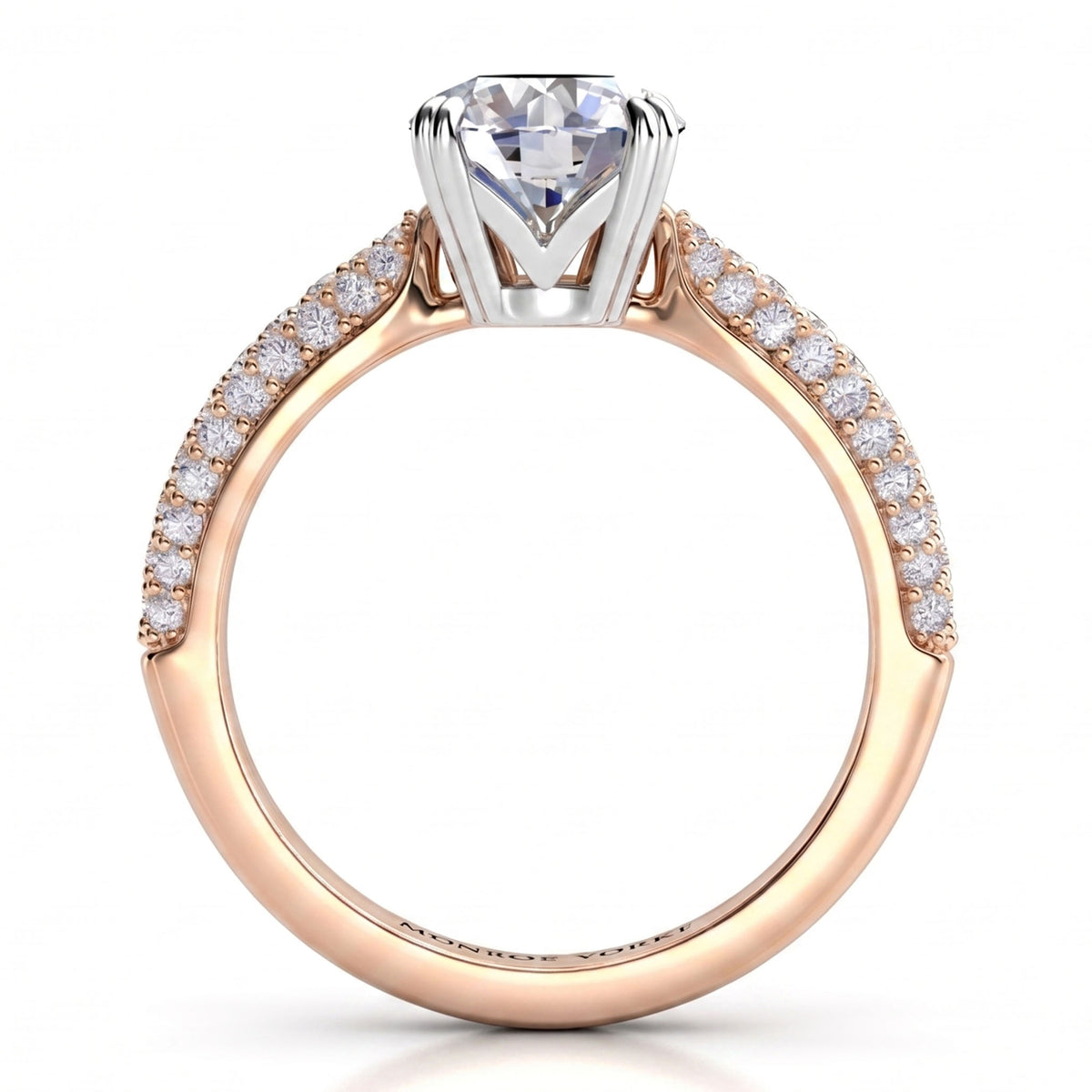 A close-up studio shot of a solitaire engagement ring featuring a round brilliant-cut diamond set in a silver-coloured prong, with a rose gold shank paved with small round diamonds.