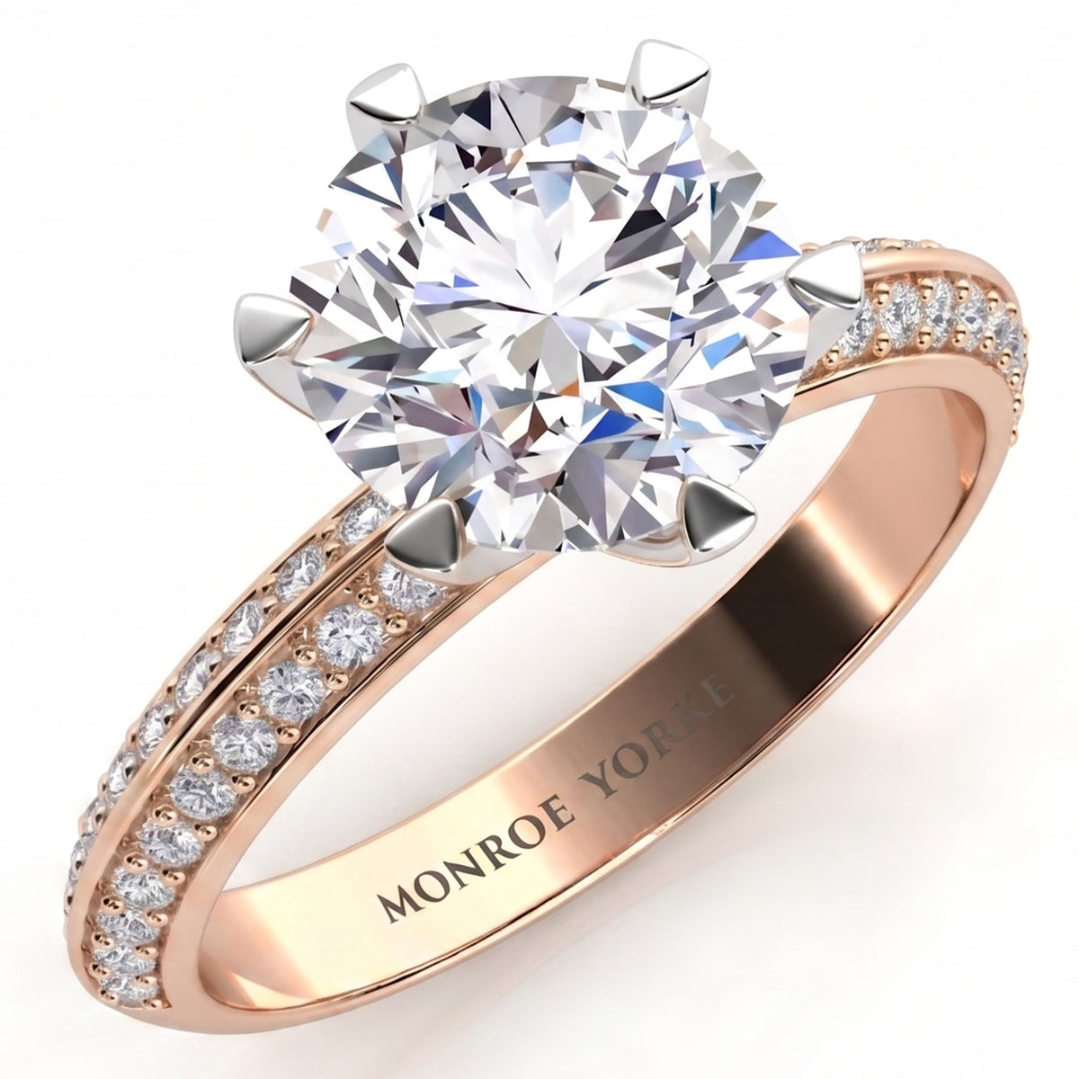 Juliet engagement ring in rose gold. Round brilliant centre diamond in a six claw setting above two rows of pave-set diamonds.