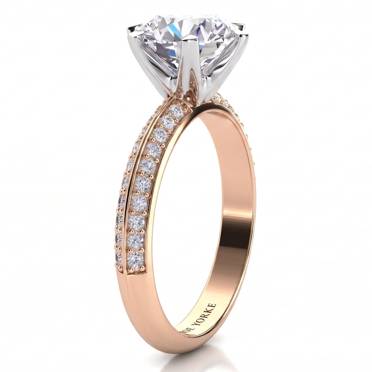 Juliet engagement ring in rose gold, side view of the knife edge band and the six claw centre setting.