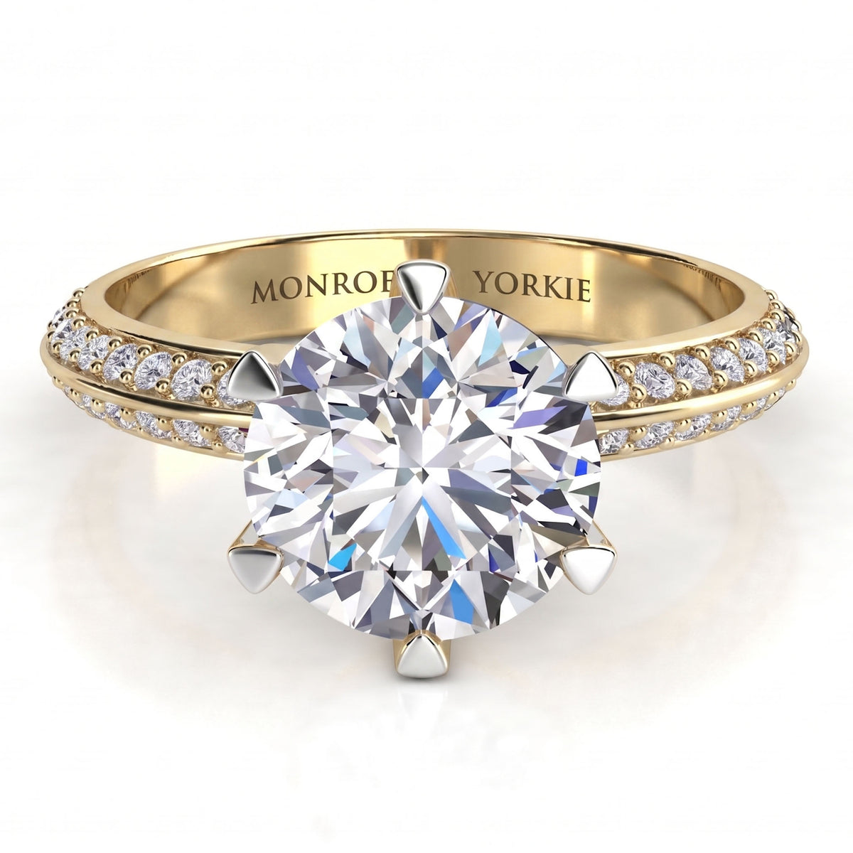 Juliet - a yellow gold engagement ring with a round brilliant-cut centre stone and two rows of pavé-set accent stones on the band, Knife edge band. Centre 6 prong setting.