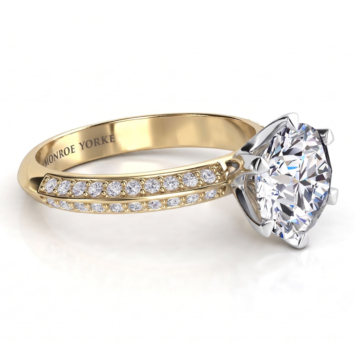 Juliet engagement ring in yellow gold. Knife edge band with pave-set diamonds either side of the six claw centre setting.