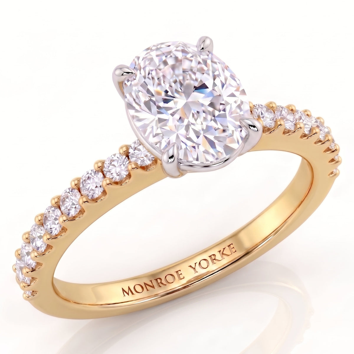 Kendall - yellow gold engagement ring featuring a large oval-cut diamond center stone and round diamonds on the band, with 'MONROE YORKE' engraved inside the band.