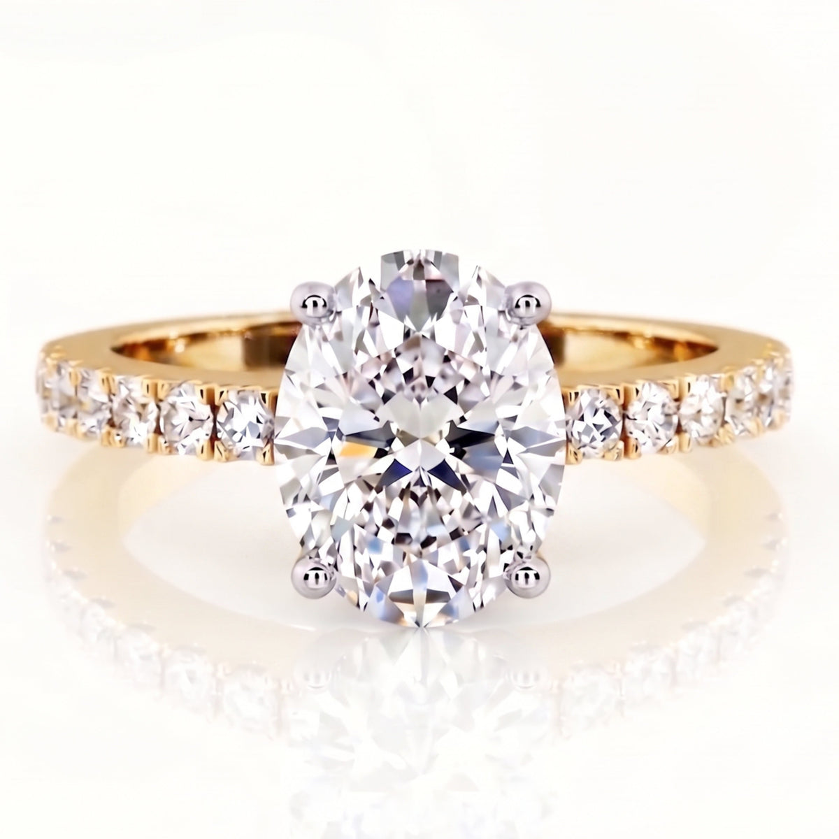 Kendall Yellow Gold - gold oval cut diamond engagement ring with diamonds on the band. Centre diamond low setting