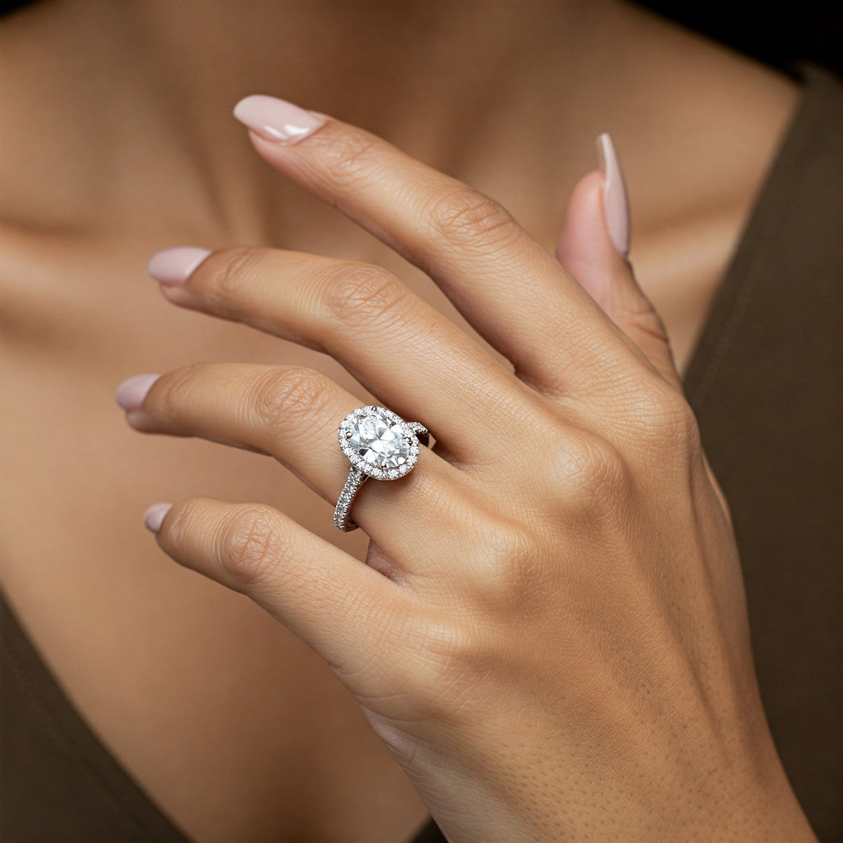 Laurel oval diamond halo engagement ring with diamond set band, detail view