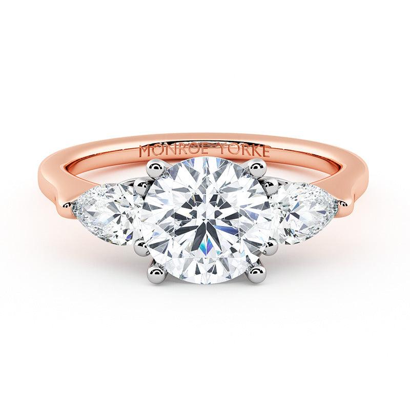 Adele - rose gold diamond trilogy ring.  Centre round diamond and pear cut diamonds on the side.