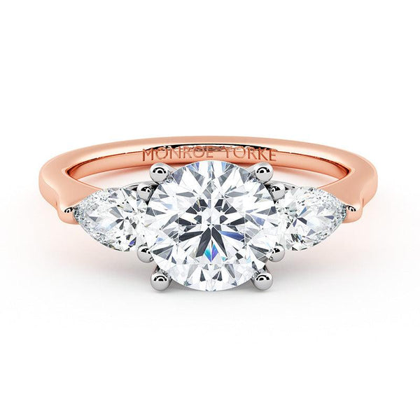 Adele - rose gold diamond trilogy ring. Centre round diamond and pear cut diamonds on the side.