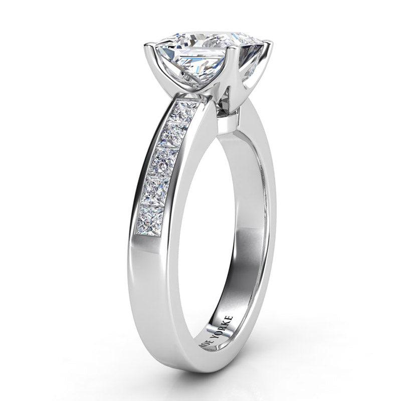 Albany Platinum - Side view showing centre basket setting. Princess cut centre diamond with channel set princess cut diamonds on the band. — view 4