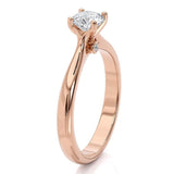 Asti - Rose gold solitaire diamond engagement ring. 4 claw setting. two diamonds set at the base of the centre setting.  Side view