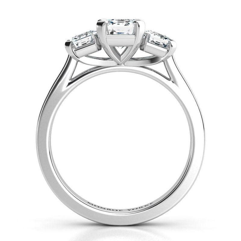Calista Platinum - emerald cut three stone ring. Side view showing the centre setting — view 5