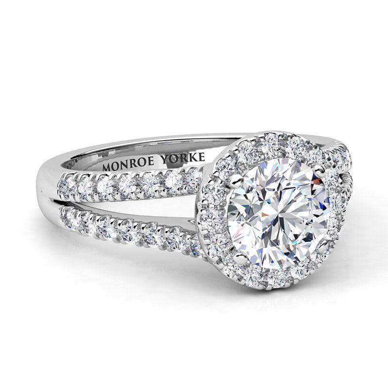 Ceduna created in platinum. Side view showing centre round diamond surrounded by a halo of diamonds and diamonds set split band. — view 4