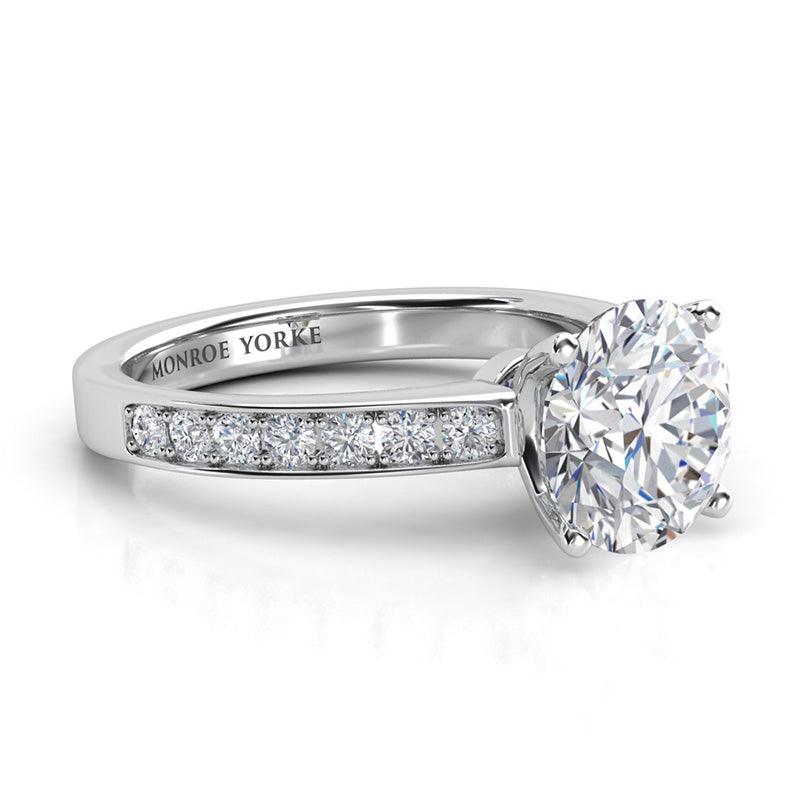 Danae - Round diamond ring in a 4 claw setting. Platinum diamond ring. Side view, showing pave set diamonds on the band — view 3