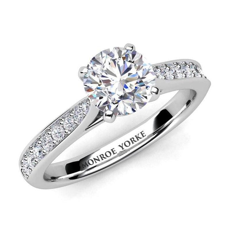 Four claw round brilliant cut diamond engagement ring with diamonds on the sweep up band. Denver in platinum — view 1