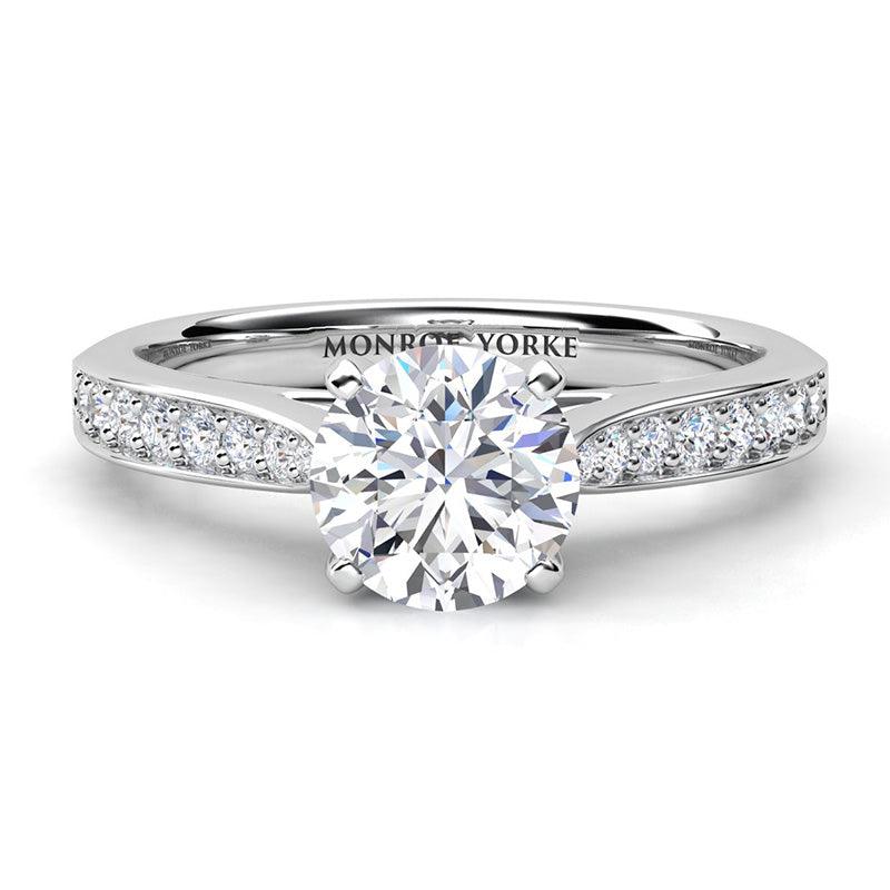 Denver GIA certified round diamond engagement ring with the centre diamond in a four claw setting.  Diamond set band that tapers into the centre setting. 18ct white gold