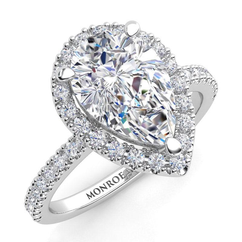 Pear shape cut diamond halo engagement ring in platinum. — view 3