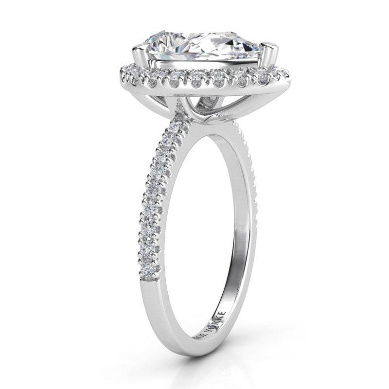 Dune pear cut diamond halo ring. Side view showing beautiful centre diamond halo setting and diamond set band.  18ct white gold