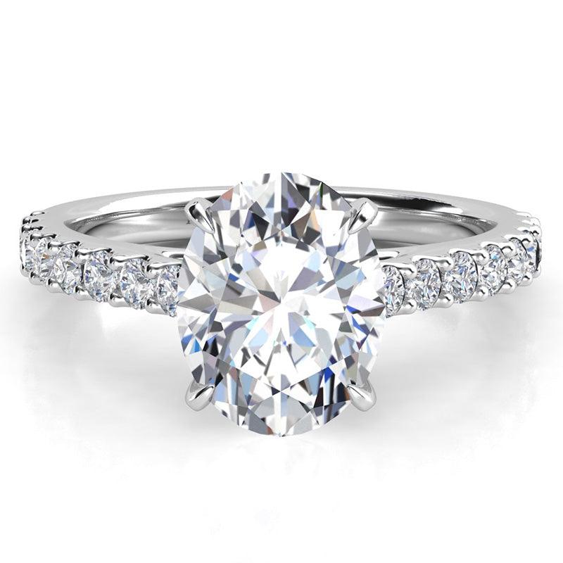 Oval Diamond Ring with diamonds on the band. 4 claw centre setting. White Gold — view 1