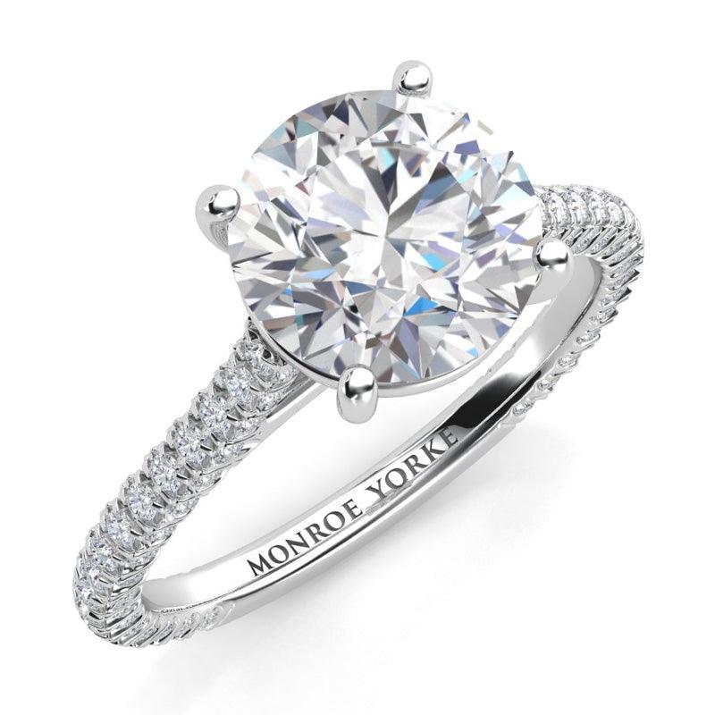 Elsie - unique diamond ring in white gold.  Centre GIA certified round diamond with pave set diamonds on three sides of the band