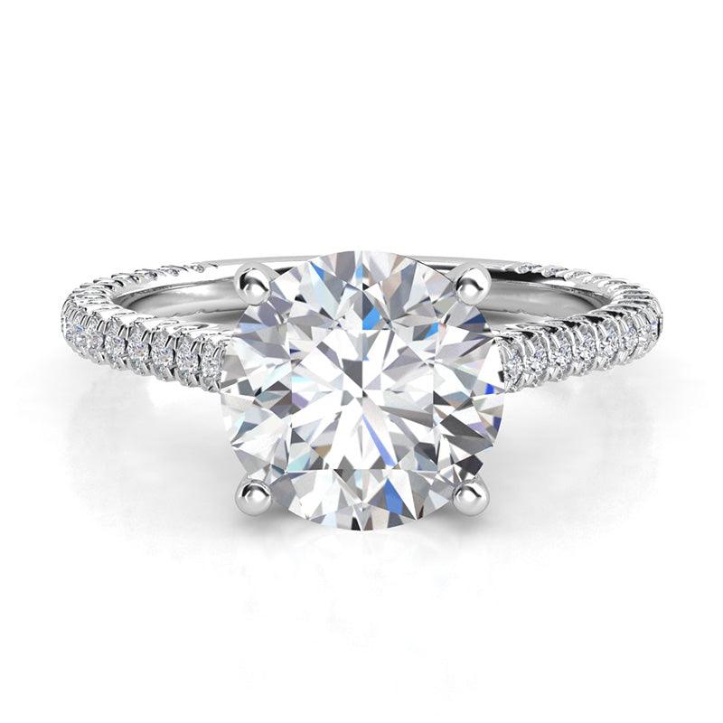 Elsie - Front view - unique diamond engagement ring in platinum.  Centre GIA certified round diamond ring in a 4 claw setting and diamonds set to three sides of the band