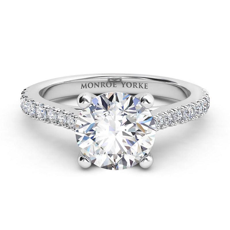 Enya in platinum.  Round diamond ring with diamonds down the band.