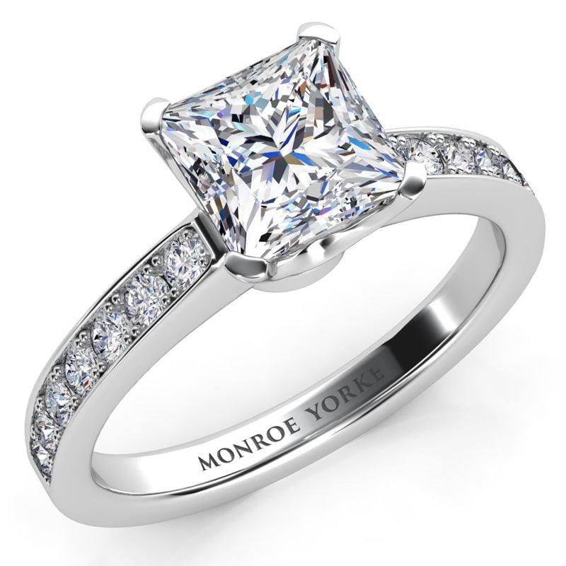 Fifth Avenue - square princess cut diamond engagement ring with round diamonds on the band. Platinum band and setting — view 2