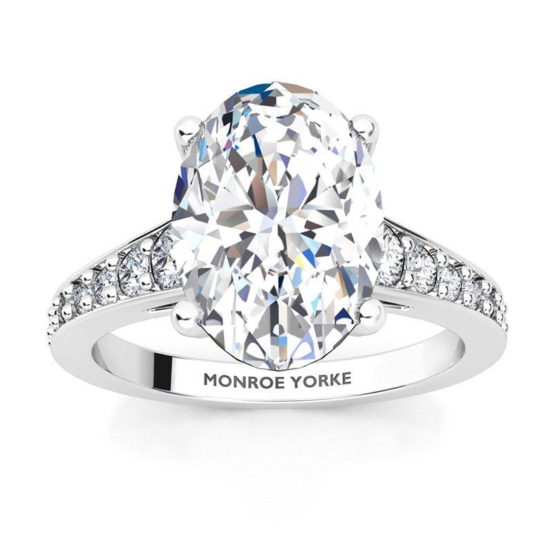 Finley engagement ring in white gold. Centre premium oval cut diamonds in a 4 claw setting. Graduated band with diamonds — view 4