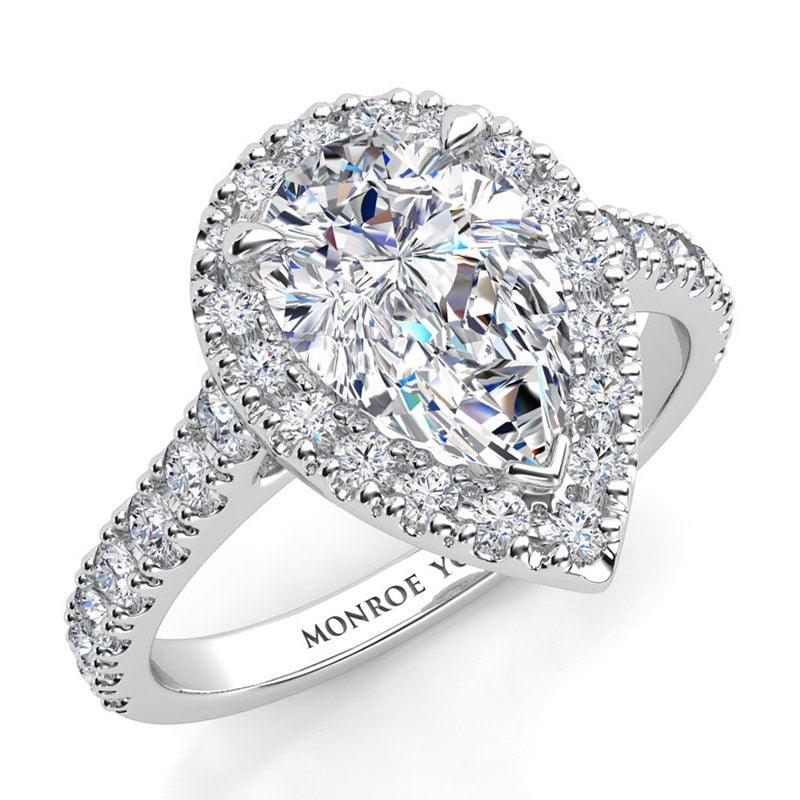 Iris - White Gold. GIA certified pear cut diamond halo engagement ring. Round brilliant cut diamonds on the sweep up band.