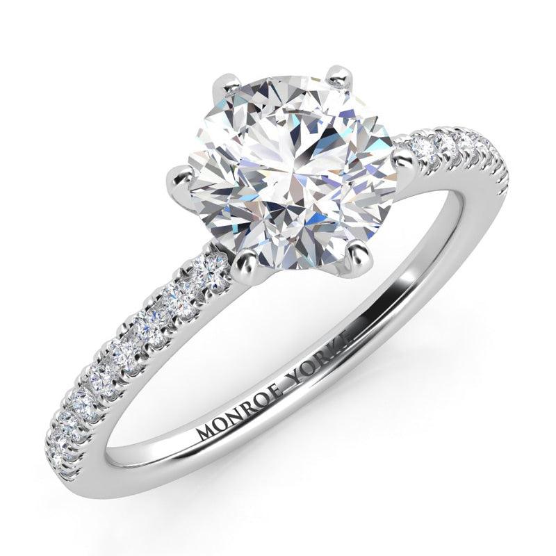 June in platinum.  centre round diamond in a six claw centre setting.  Diamonds down on the band.