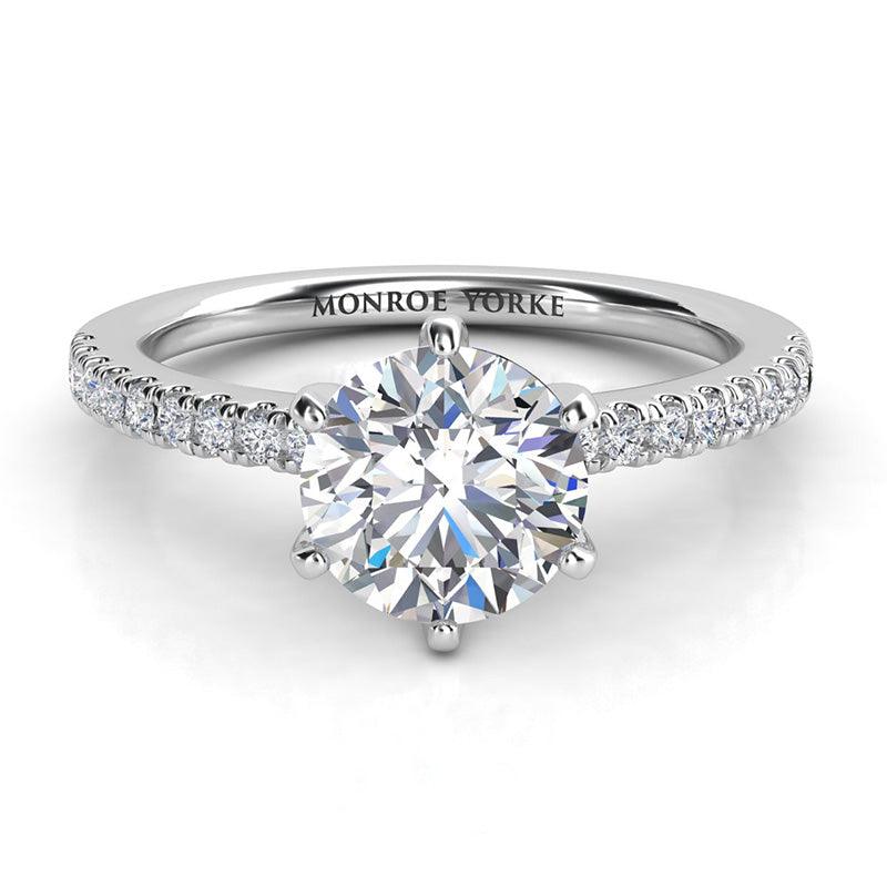 Diamond engagement ring in platinum with side diamonds. Centre diamond in a six claw setting.