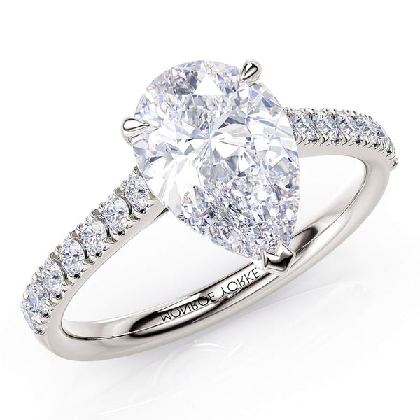 Karly pear cut diamond engagement ring. Centre 3 claw setting. Diamonds on the sweep up band. 18ct white gold or platinum.