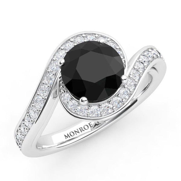 Unique black diamond halo engagement ring in platinum. White diamond set platinum band wraps the centre black diamond. Miranda