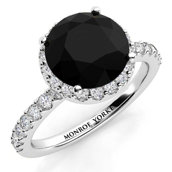Sasha in platinum: Unique Black Diamond Ring with a halo of white diamonds and diamonds down the band.