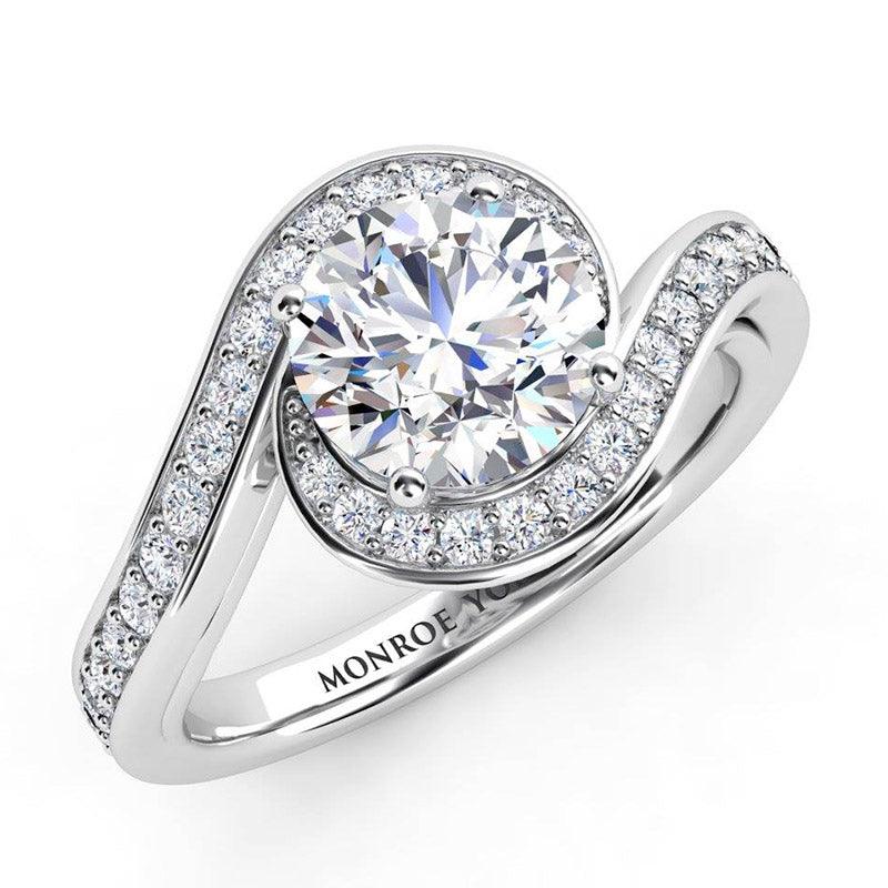 Soleil - unique halo diamond engagement ring.  Centre round diamond encircled by the diamond set band.  18ct white gold.