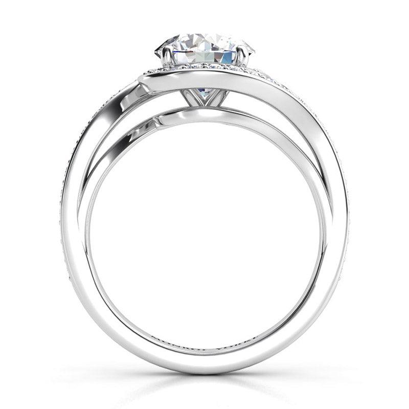 Side view 3showing the unique halo that wraps the centre round diamond. Tempest, created in platinum. — view 5