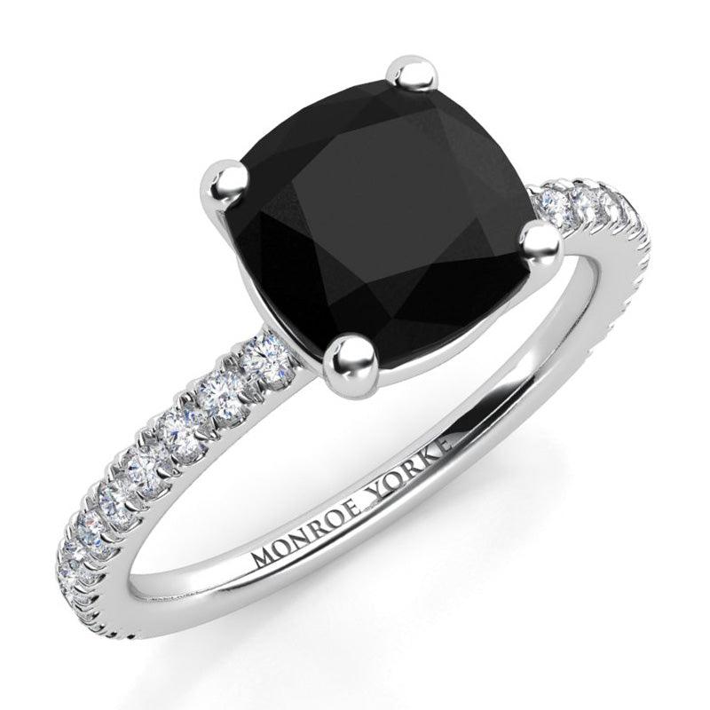 Storm - Cushion cut black diamond ring with white diamonds on the band.  Made in platinum. 